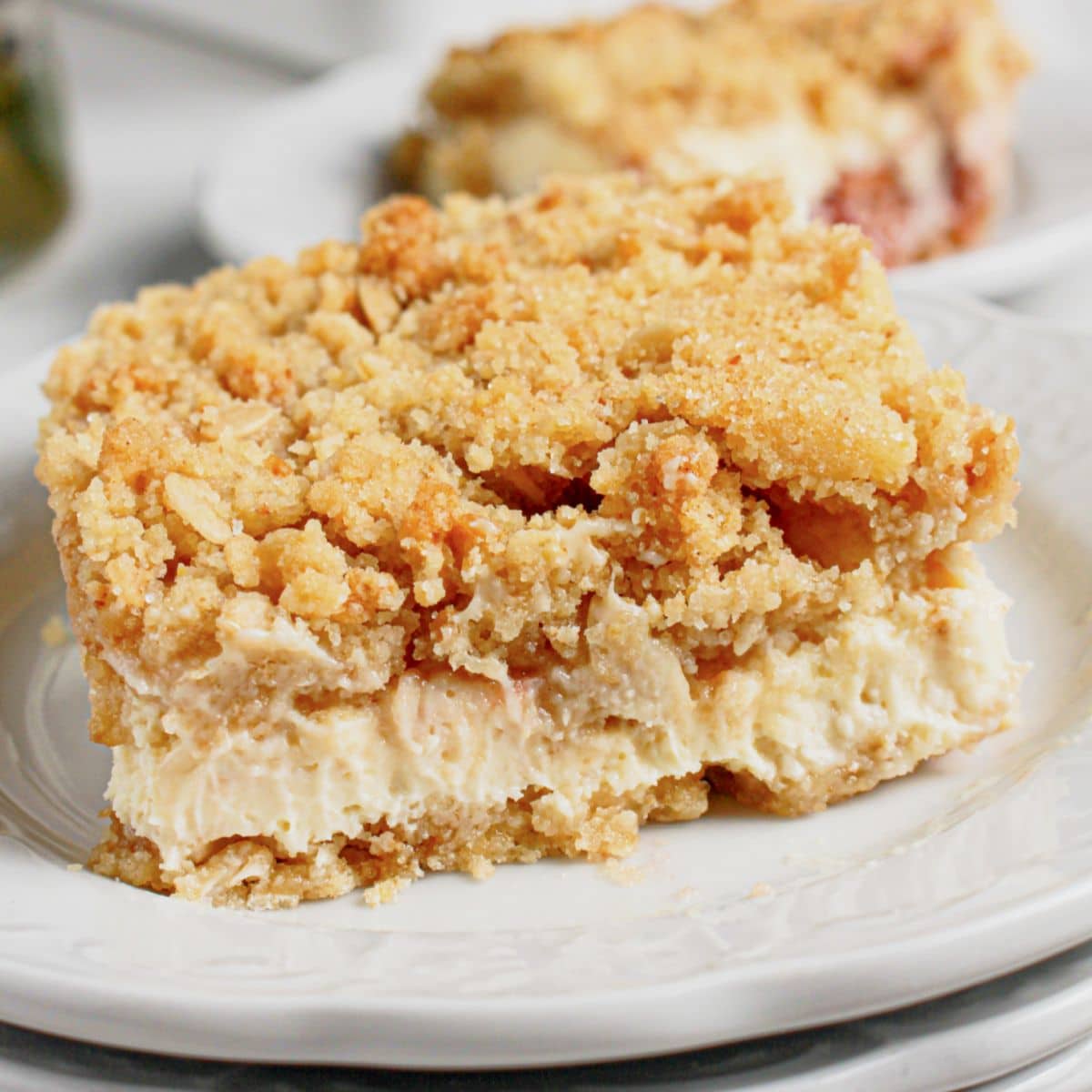 Slice of lemon cheesecake crumb bars on a plate.
