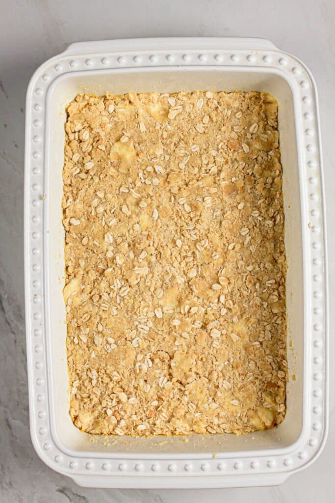 Crust pressed into the bottom of a white baking dish.
