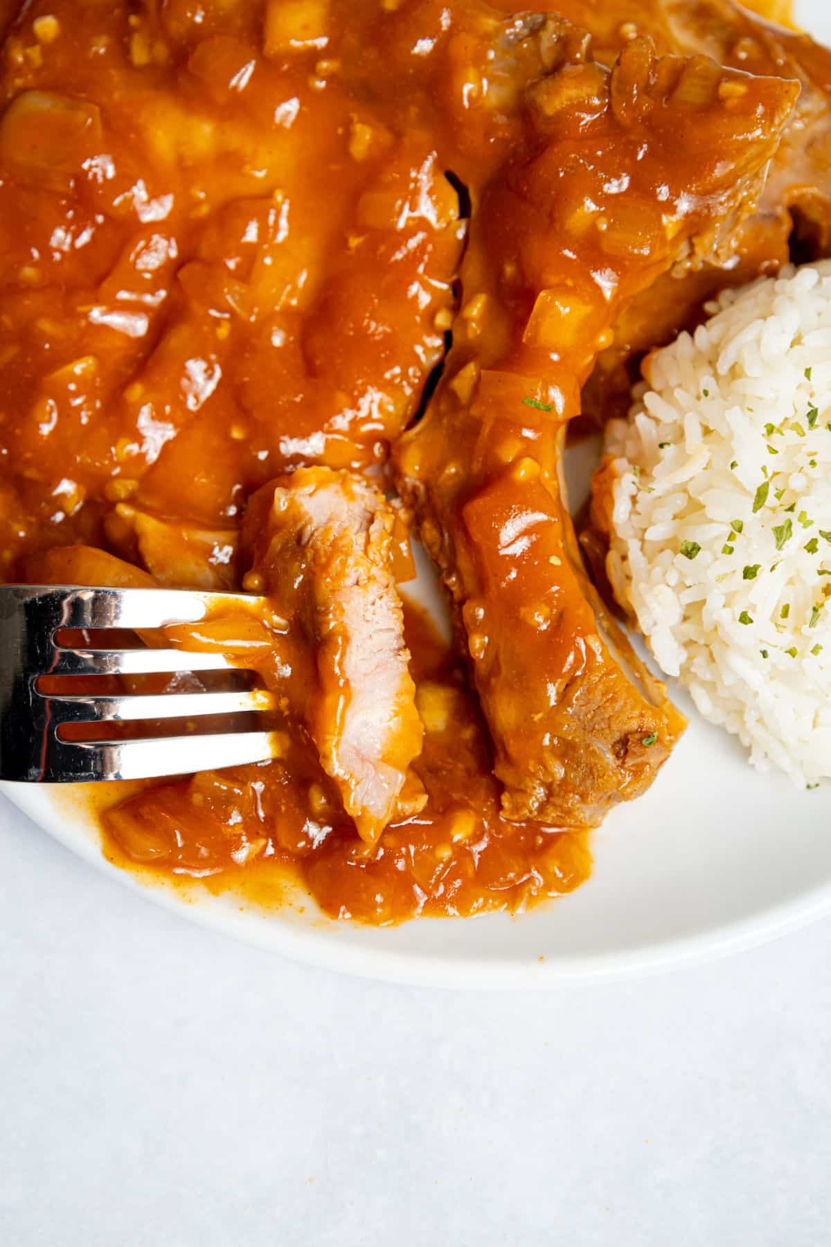 Bite of pork chops on a plate.