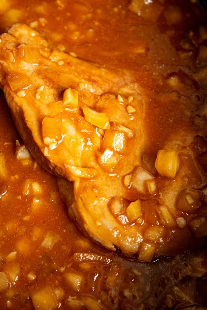 Pork chops and onions in a slow cooker.