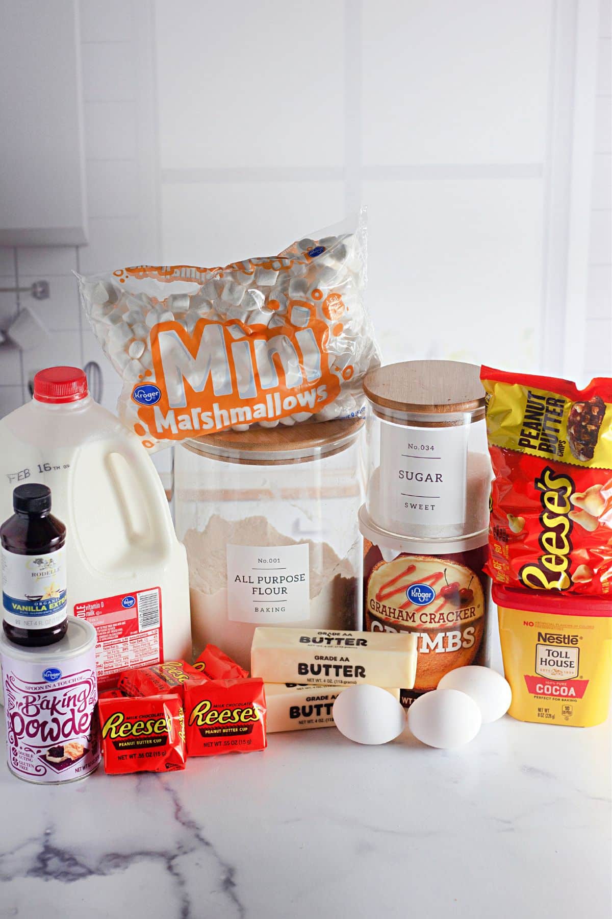 Ingredients to make smores brownies in their containers on a counter.
