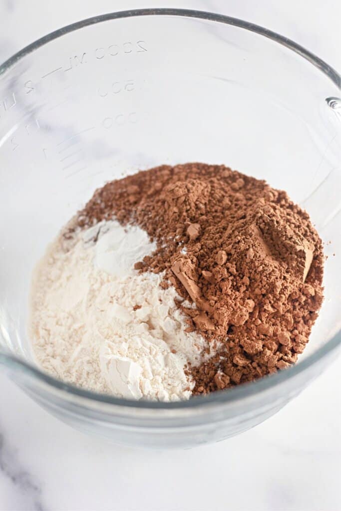 Dry ingredients being mixed in a glass mixing bowl.