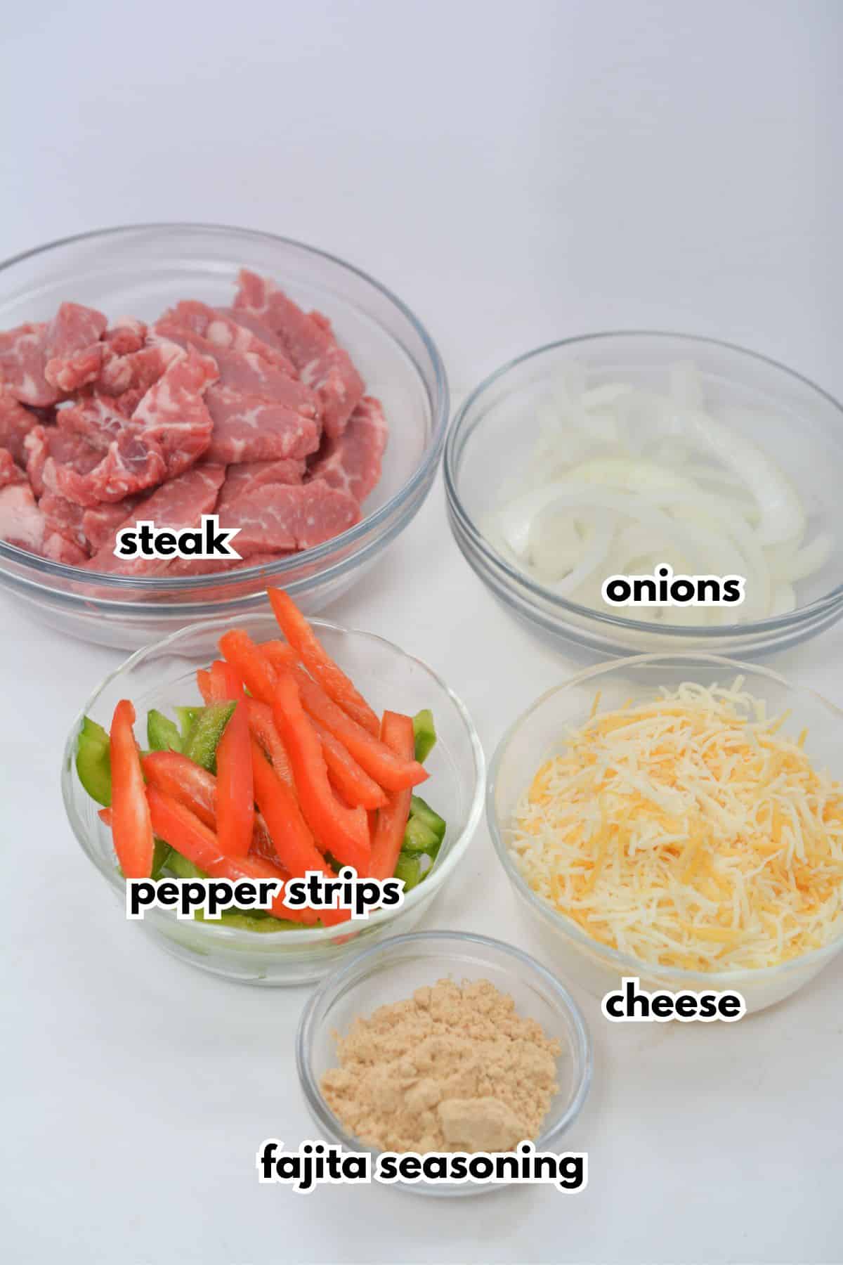 Bowls of ingredients labelled with text on a counter.