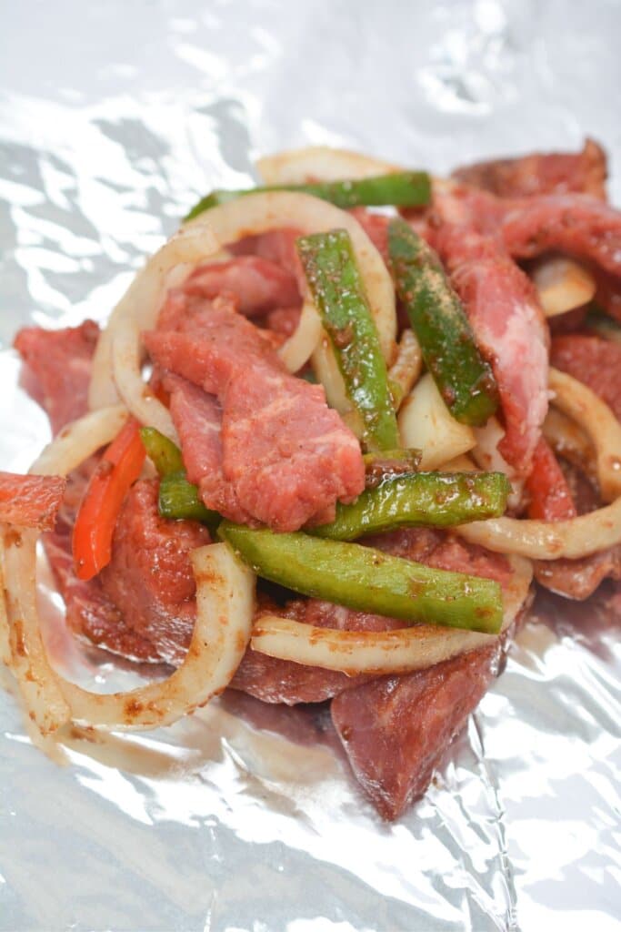 Meat and veggies on a baking sheet.
