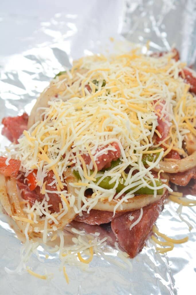 Cheese being sprinkled on top of veggies.
