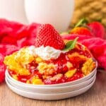 Strawberry cheesecake dump cake on a small plate.