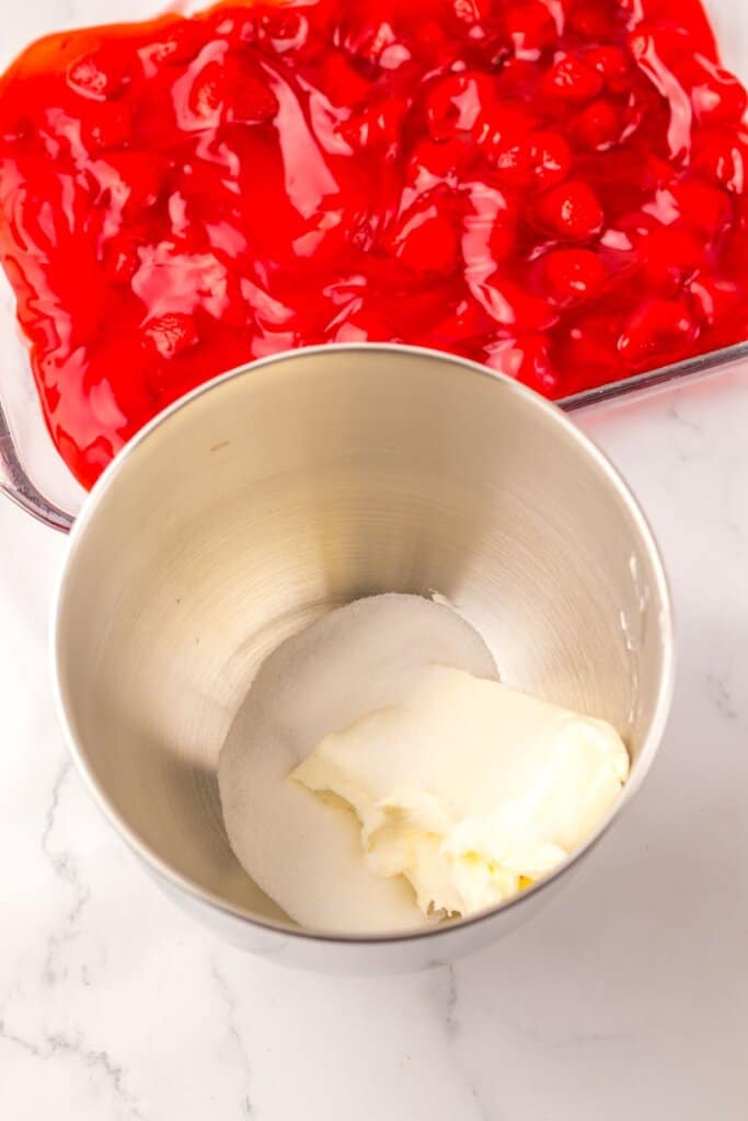 Cream cheese and sugar in a mixing bowl.