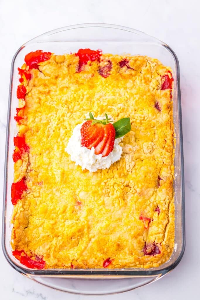 Strawberry dump cake in a glass baking dish.