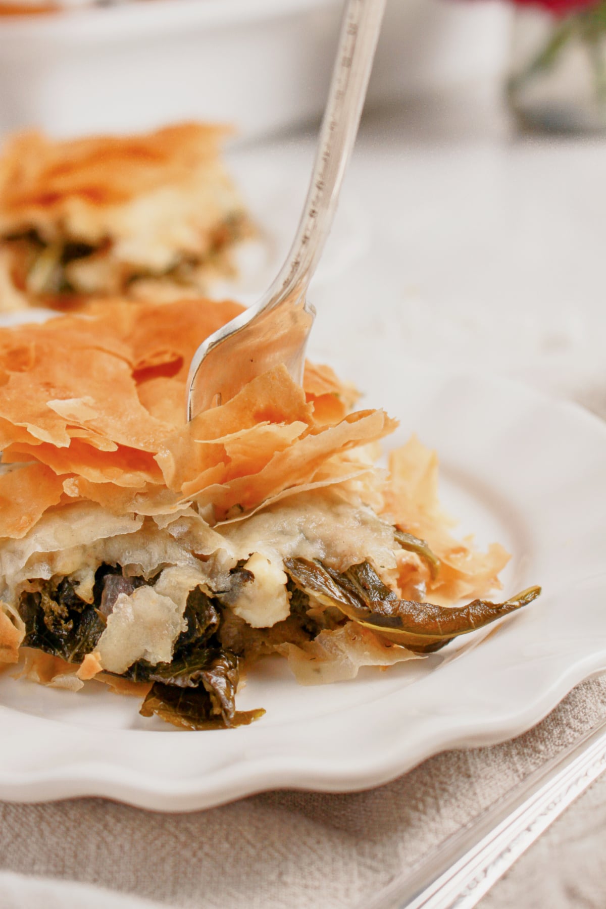 Slice of spanakopita on a plate.