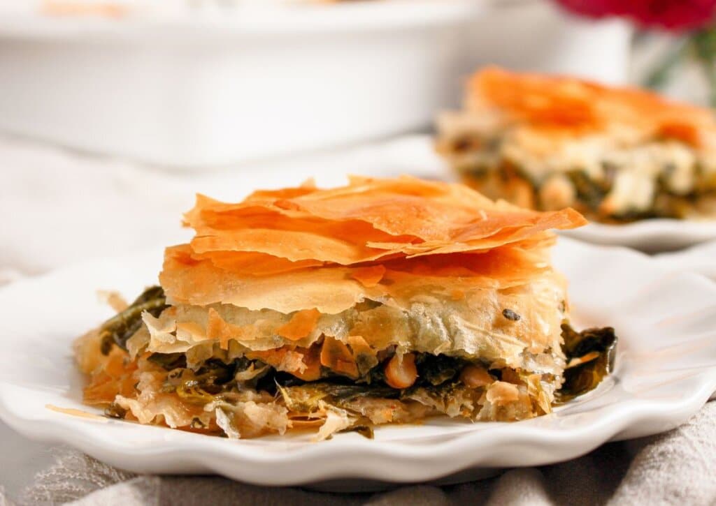 Slice of spanakopita on a plate.