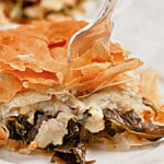 Slice of spanakopita on a plate.