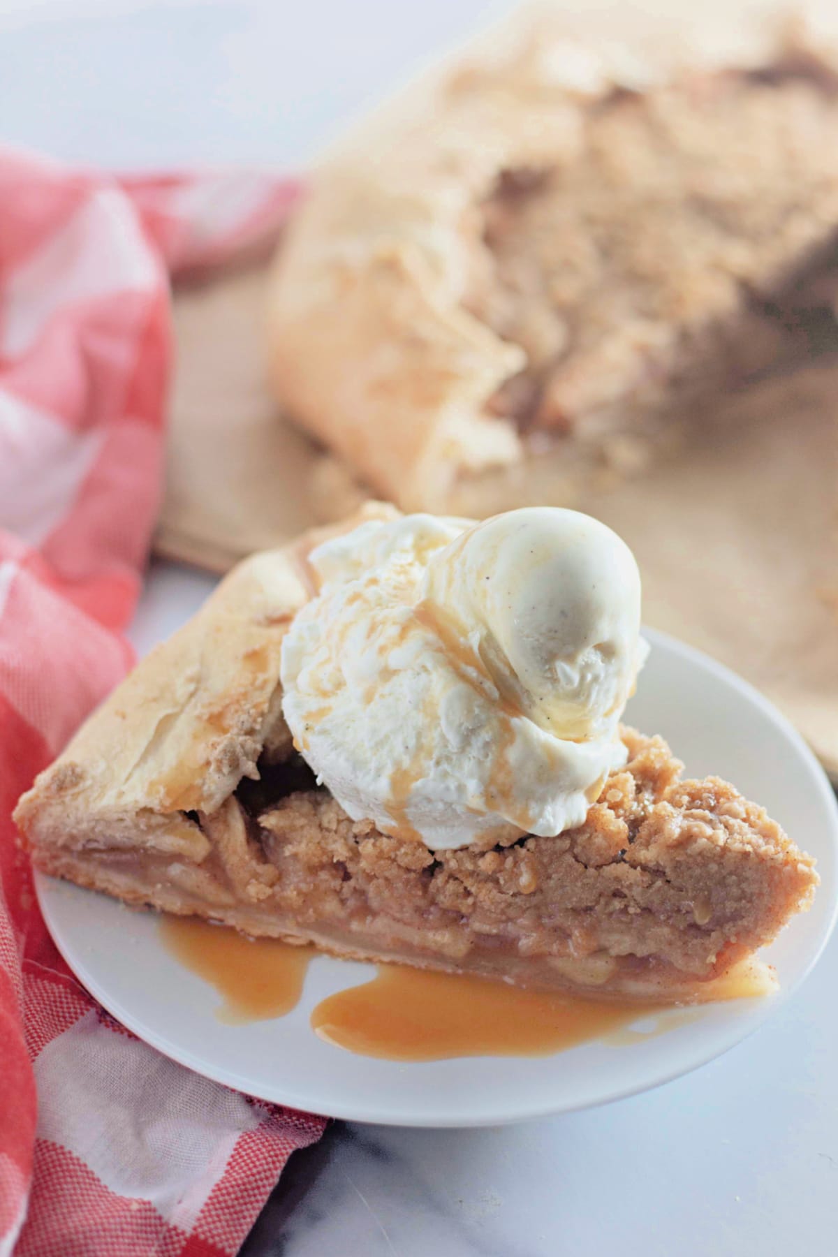 Slice of apple crumb galette on plate.