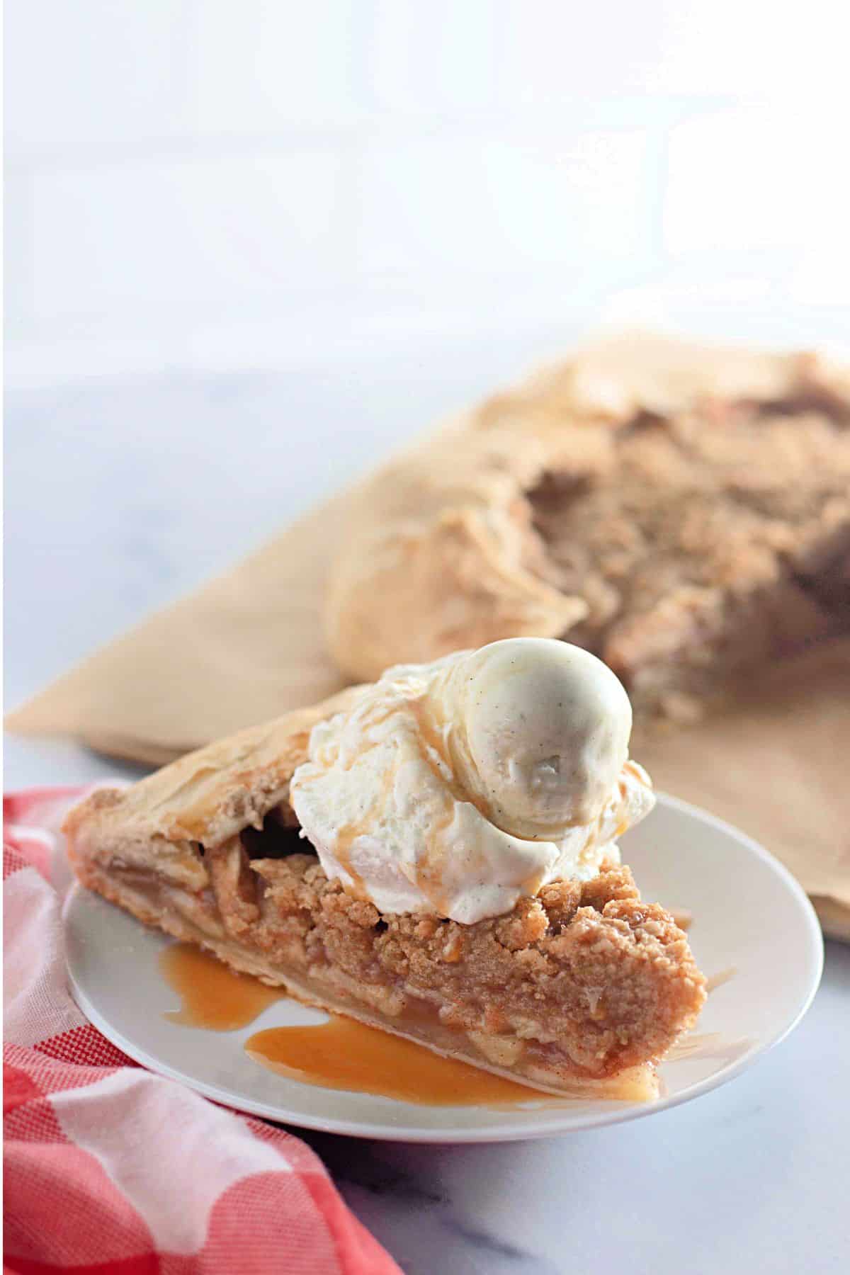 Slice of apple crumb galette on plate.