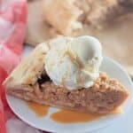 Slice of apple crumb galette on plate.
