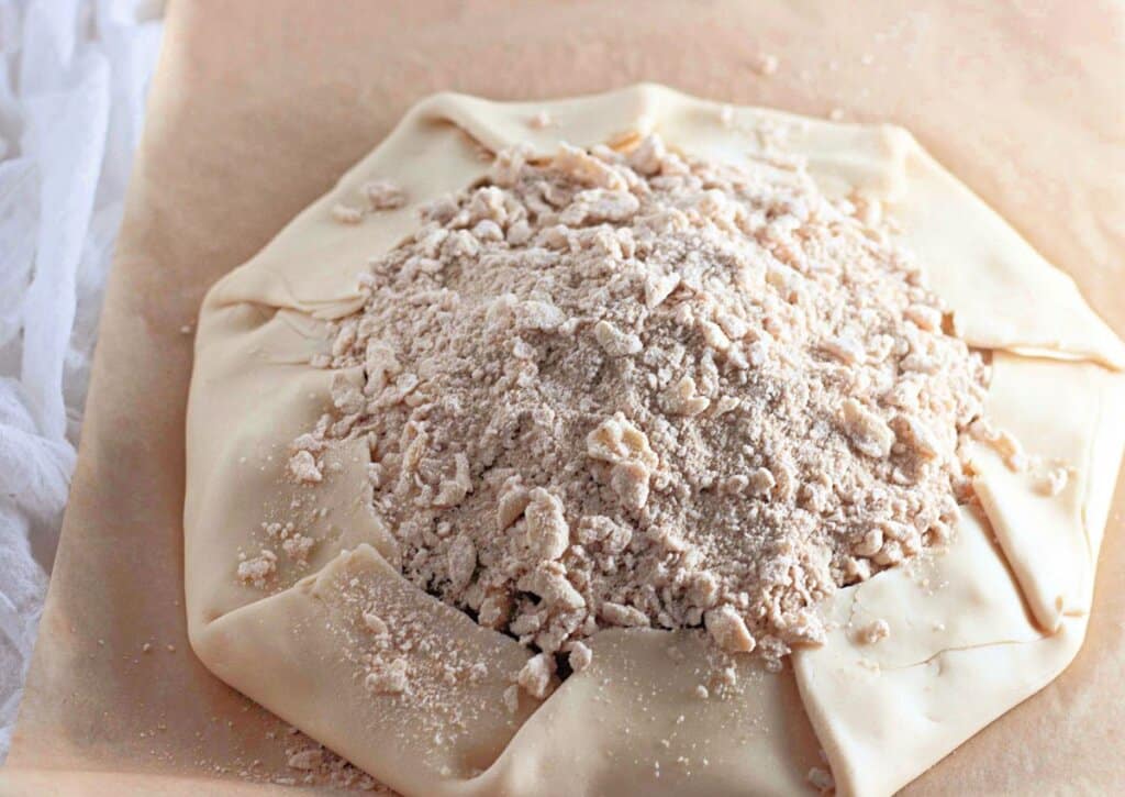 Topping being sprinkled on top of dessert.