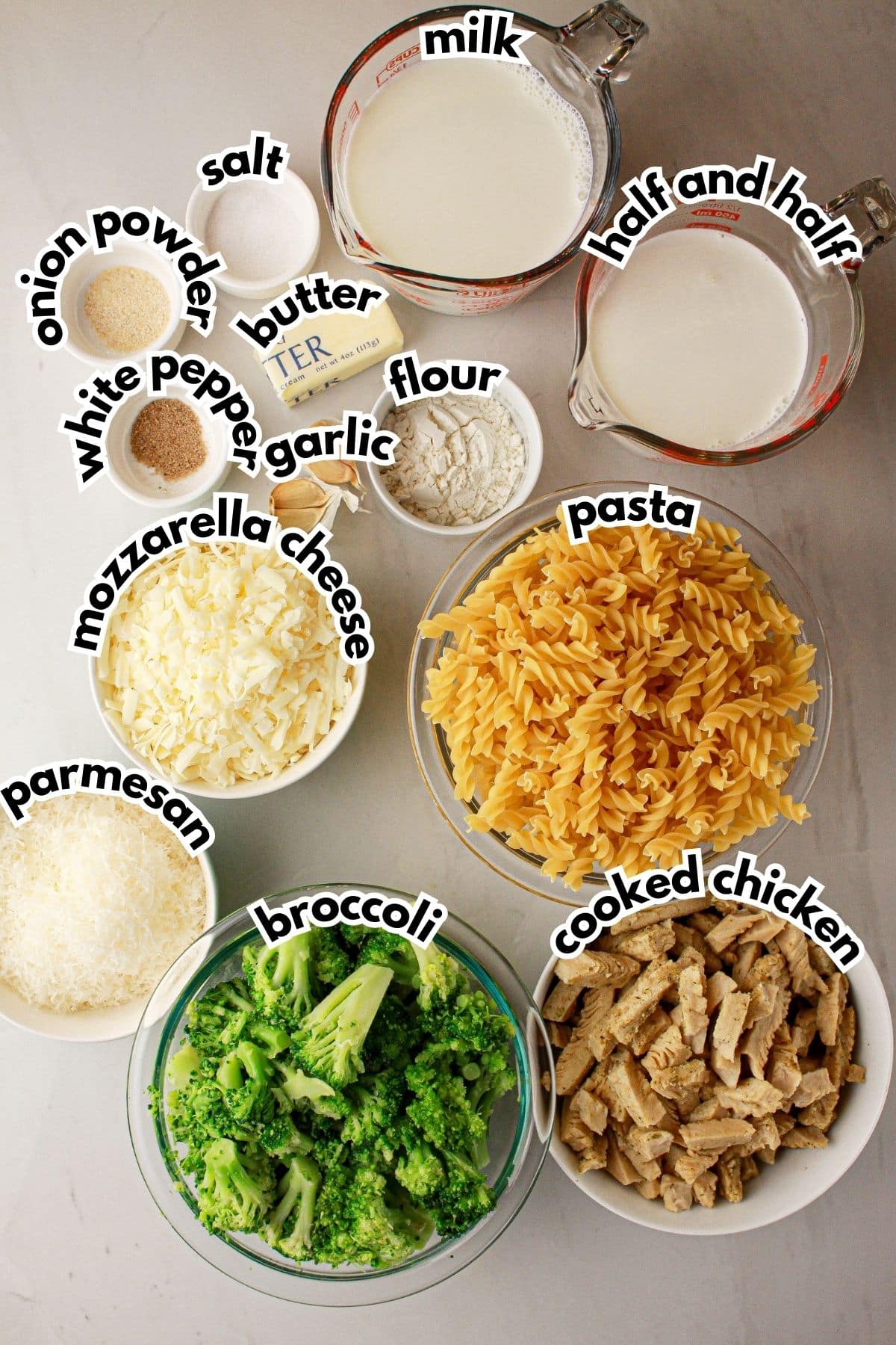 Bowls of ingredients labelled with text on a counter.