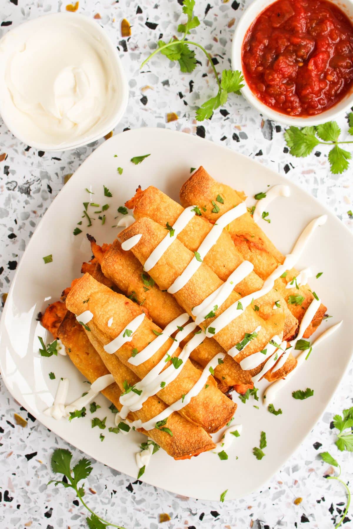 Chicken taquitos on a plate.