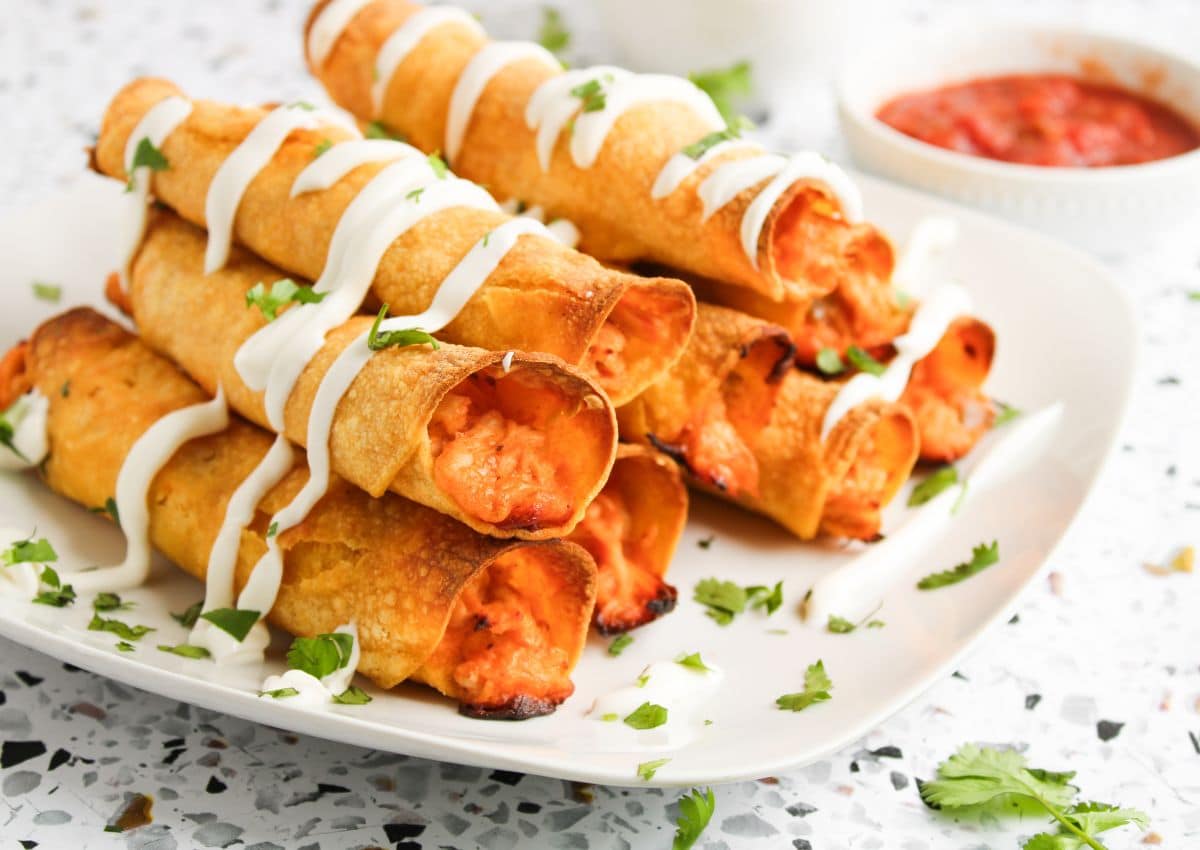 Baked taquitos on a plate.