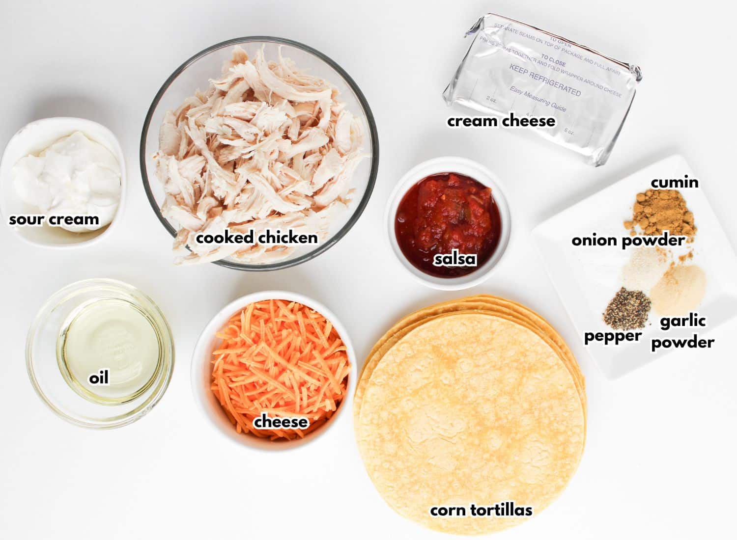 Bowls of ingredients labelled with text on a counter.
