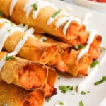 Chicken taquitos on a plate.