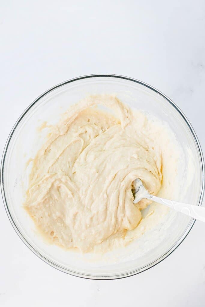 Batter being mixed in a glass bowl.