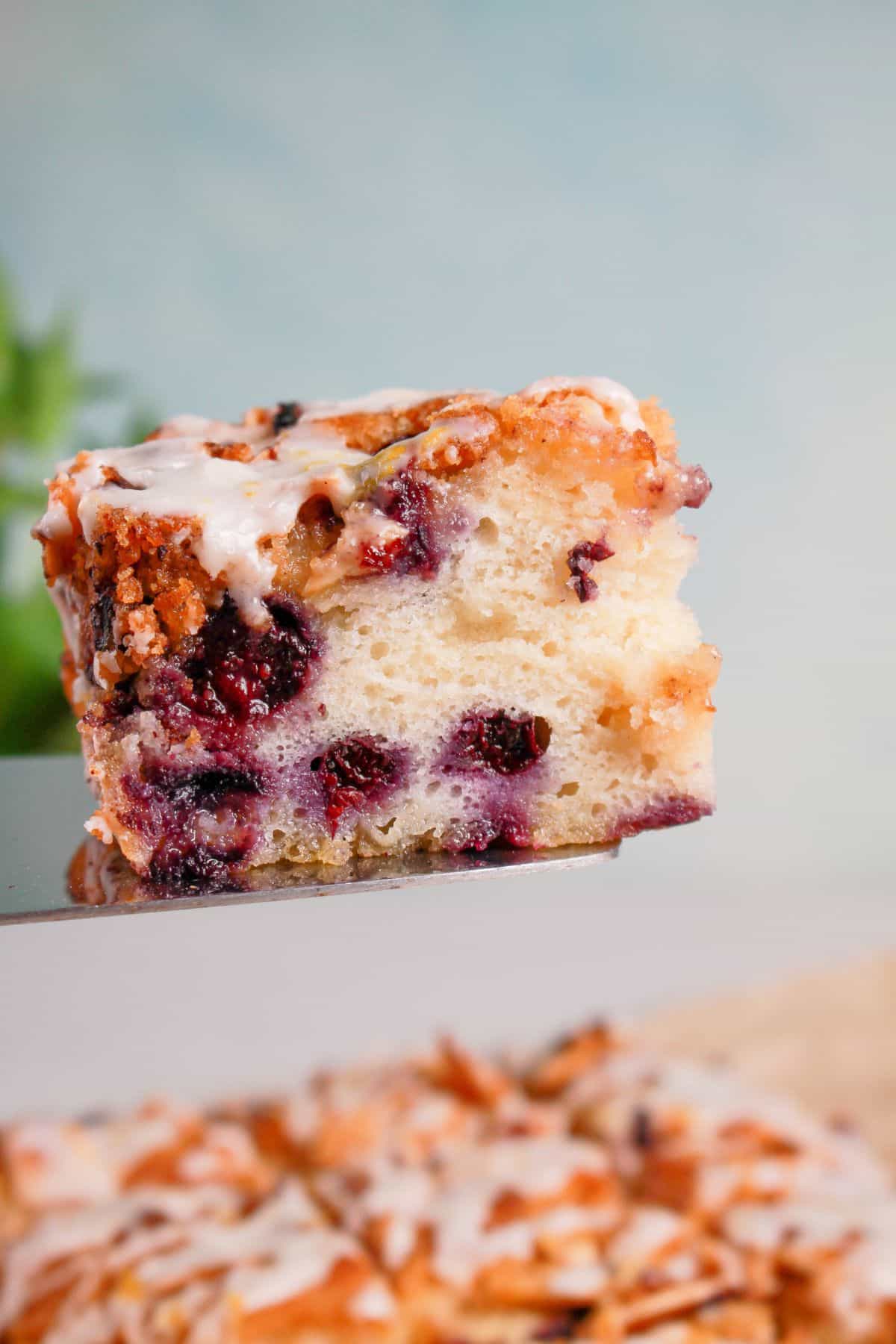 Slice of blueberry butter swim biscuit on a spatula.