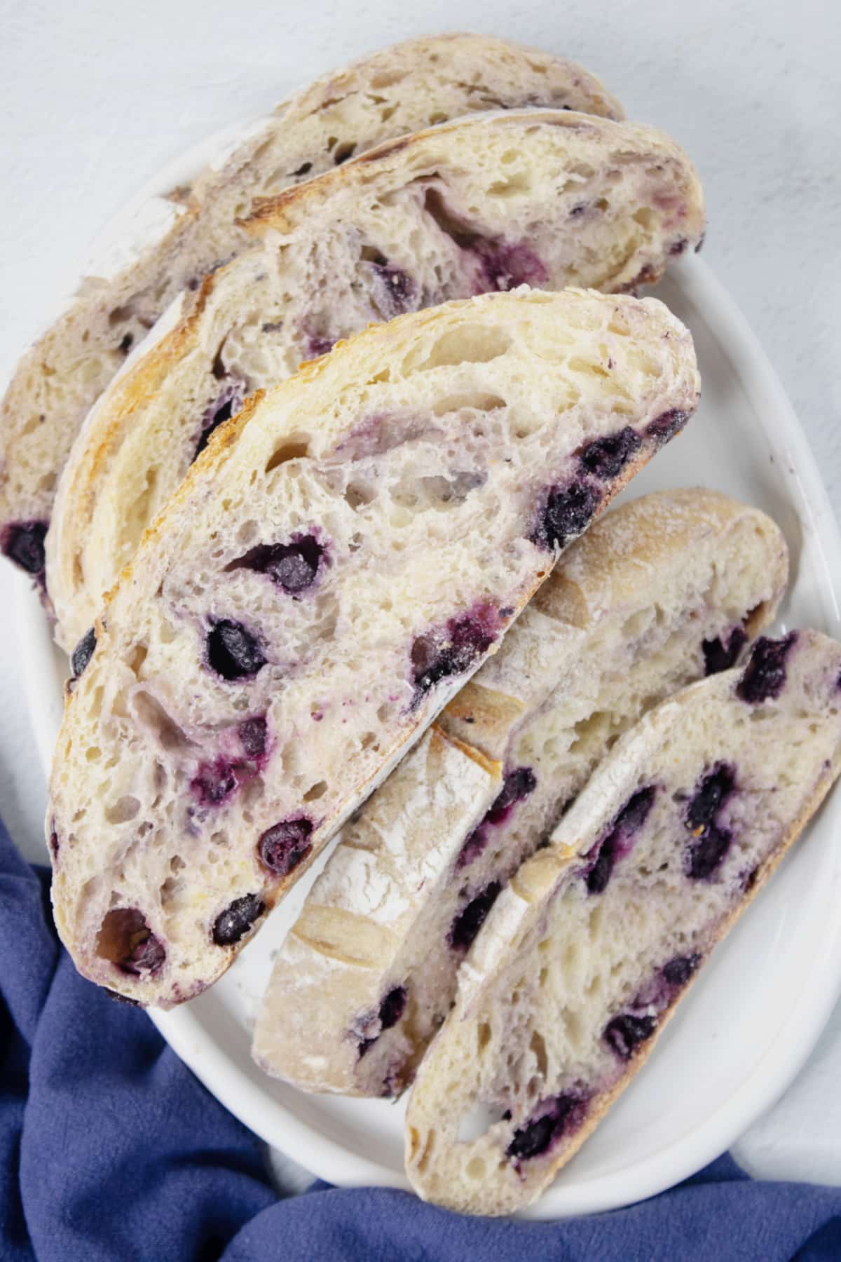 Slices of blueberry sourdough bread on a platter.