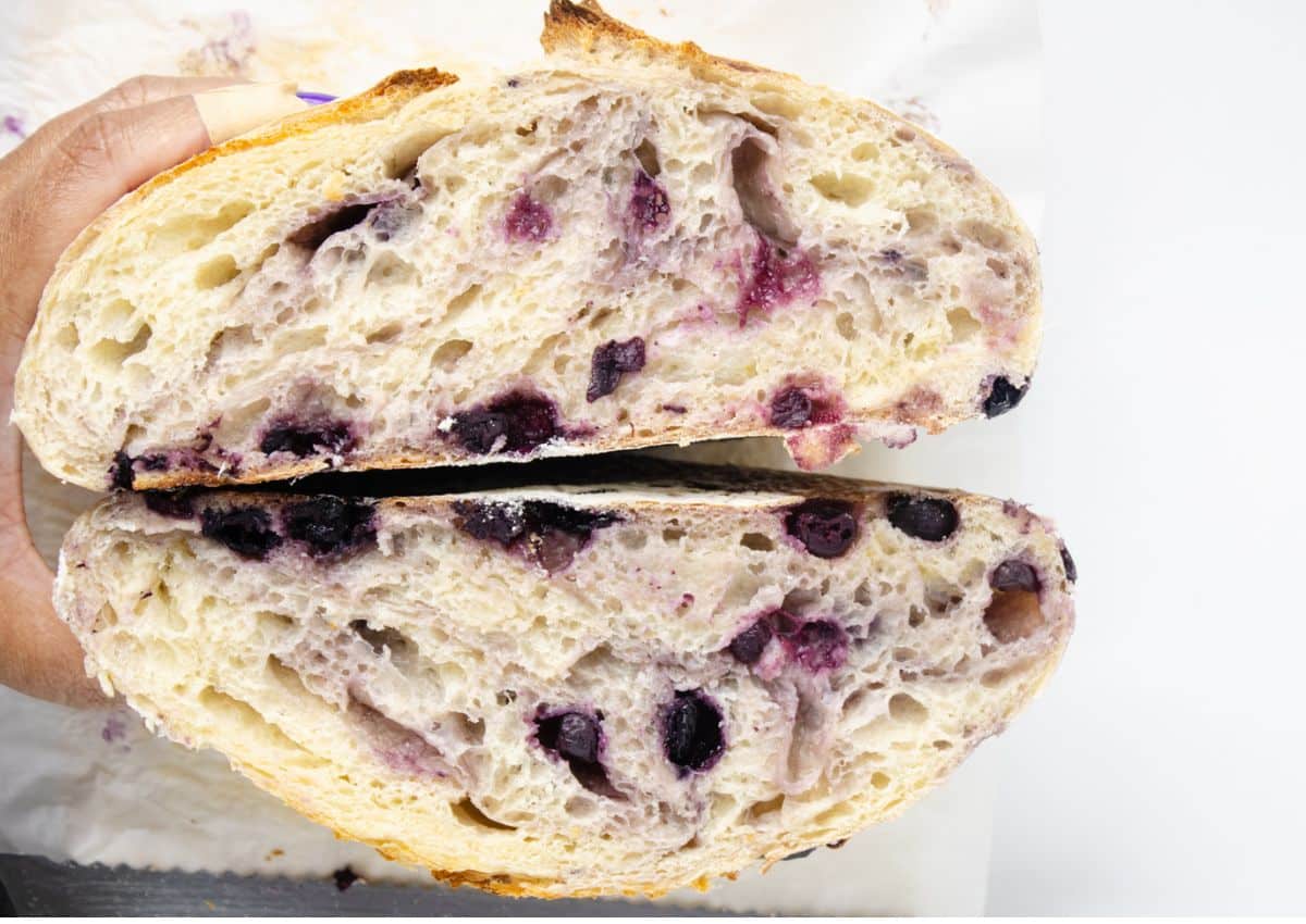 Loaf of blueberry sourdough bread cut open.