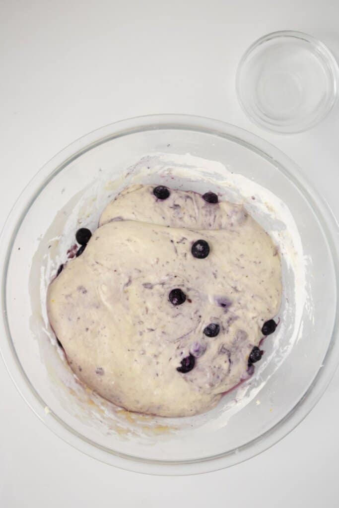 Dough rising in a glass bowl.