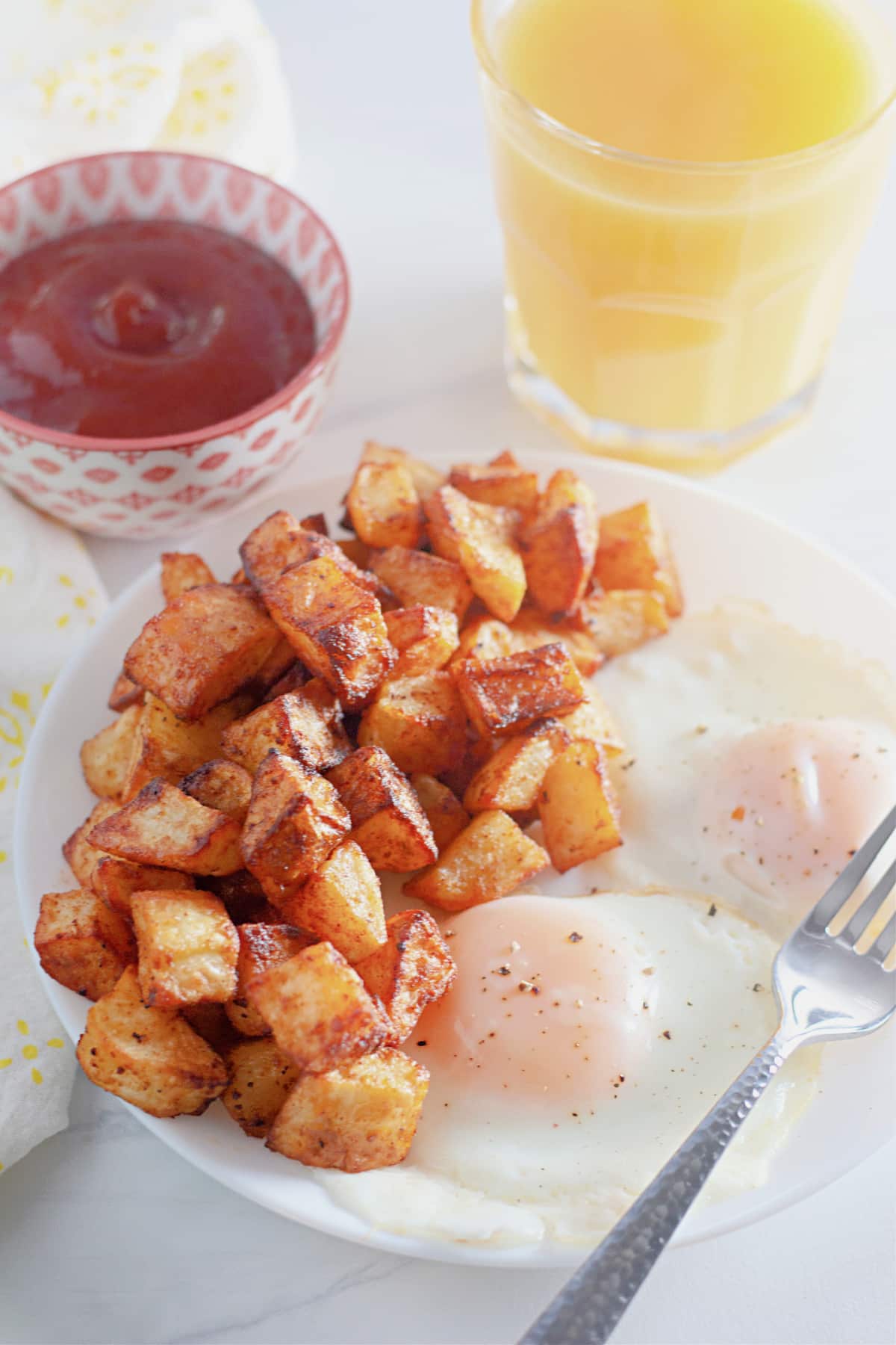 Diced potatoes on a plate with eggs.
