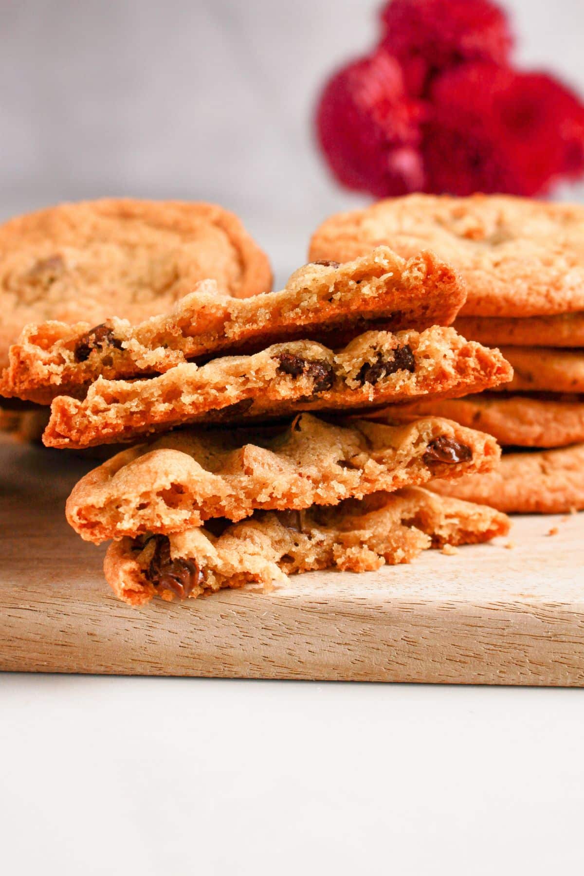 Butterscotch chocolate chip cookies broken in half on a cutting board.