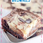 Slice of chocolate cheesecake brownies on a metal spatula.