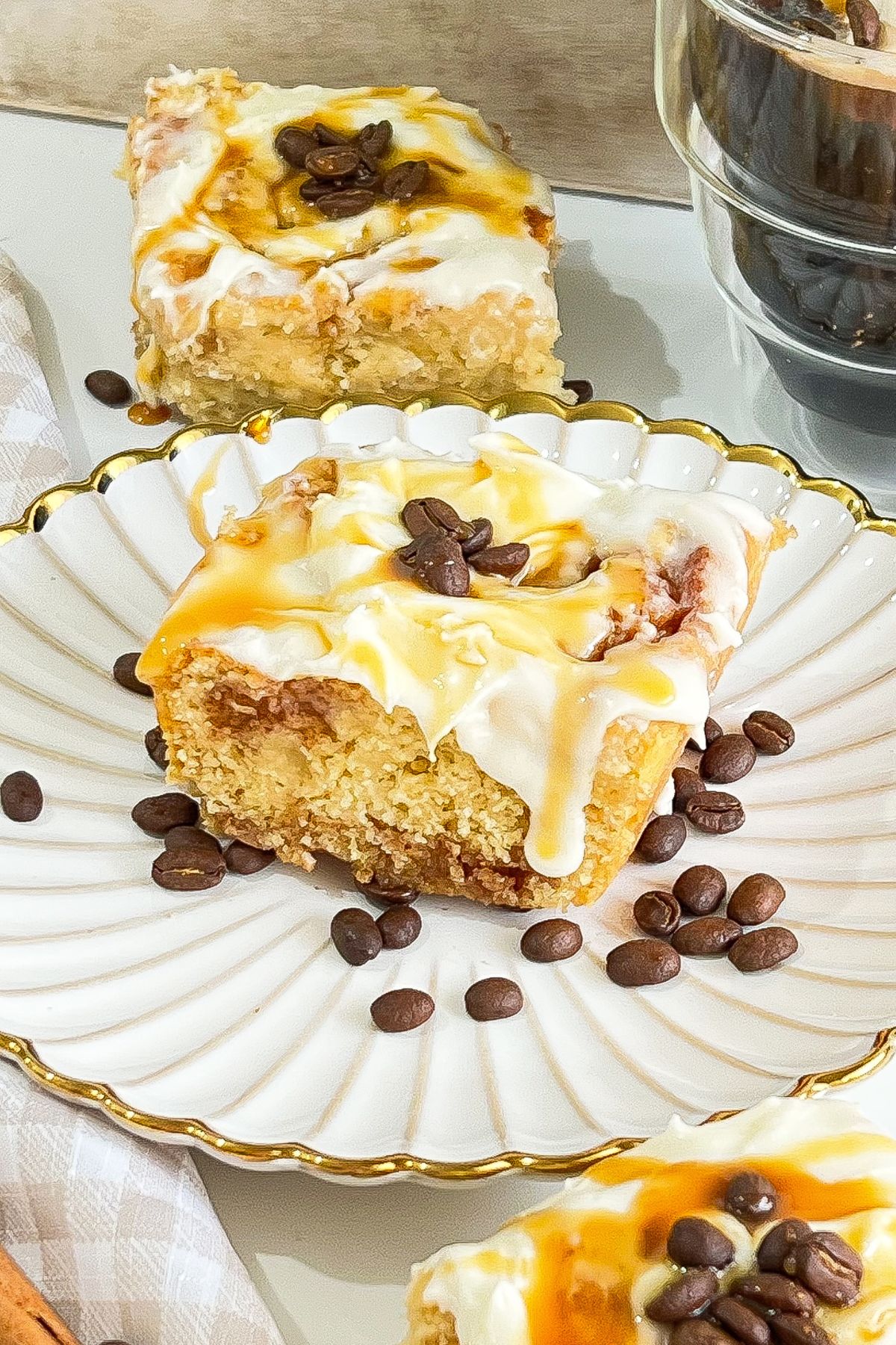 Coffee cinnamon roll on a white plate.