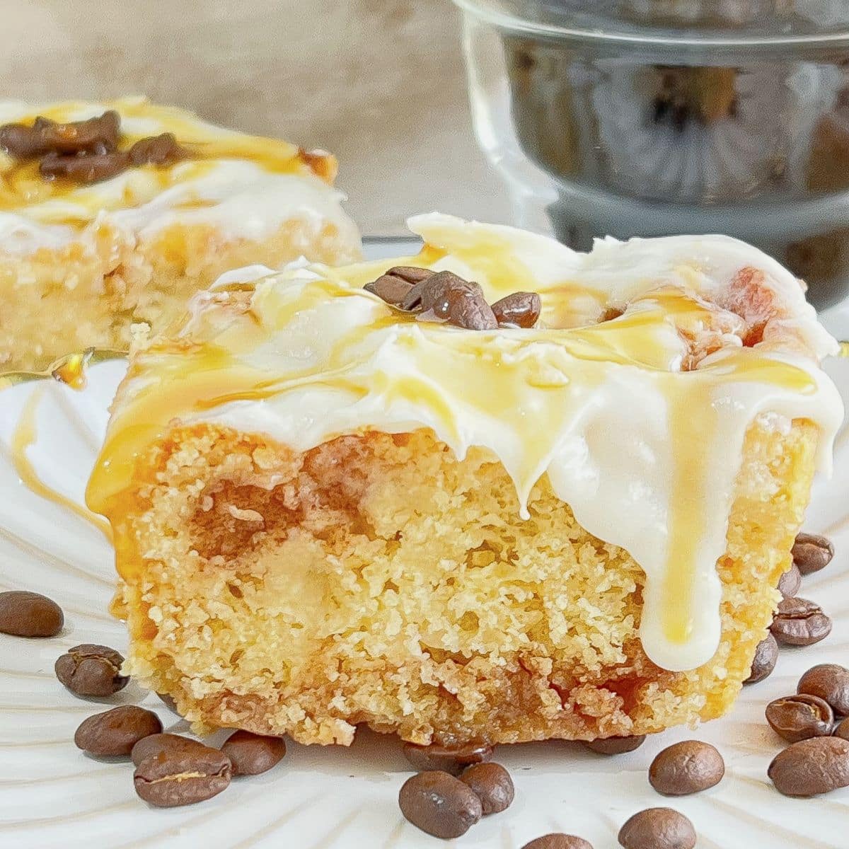 Coffee cinnamon roll on a white plate.