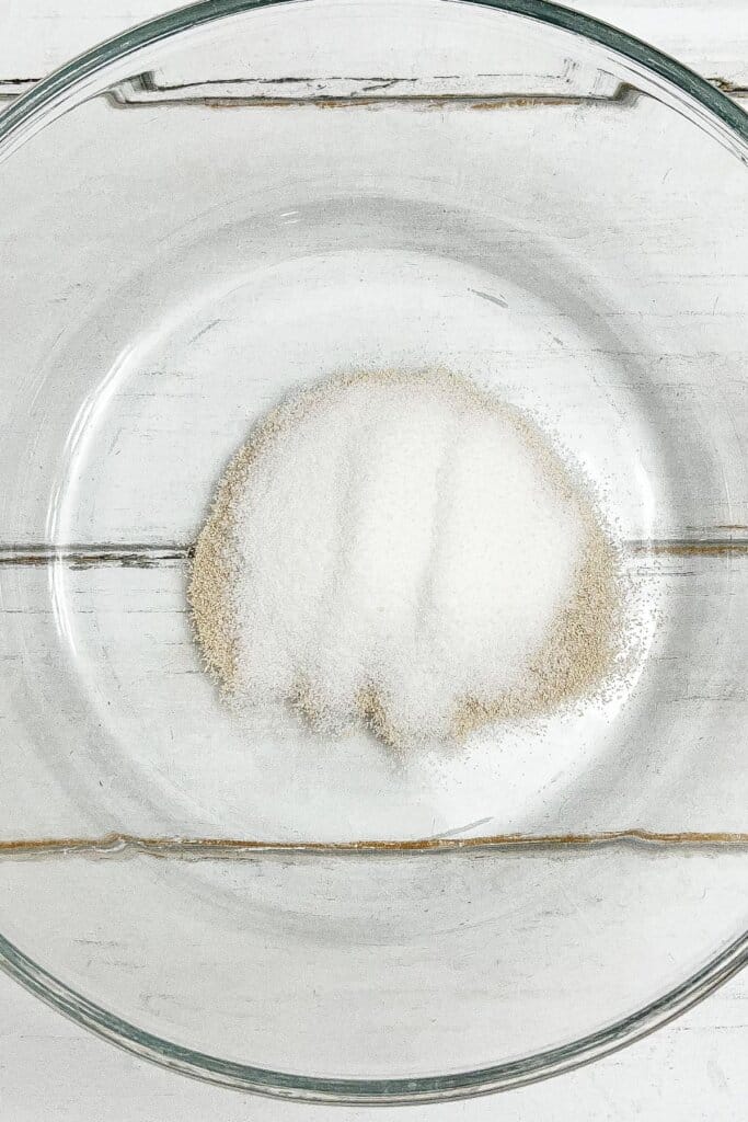 Sugar and yeast in a glass bowl.
