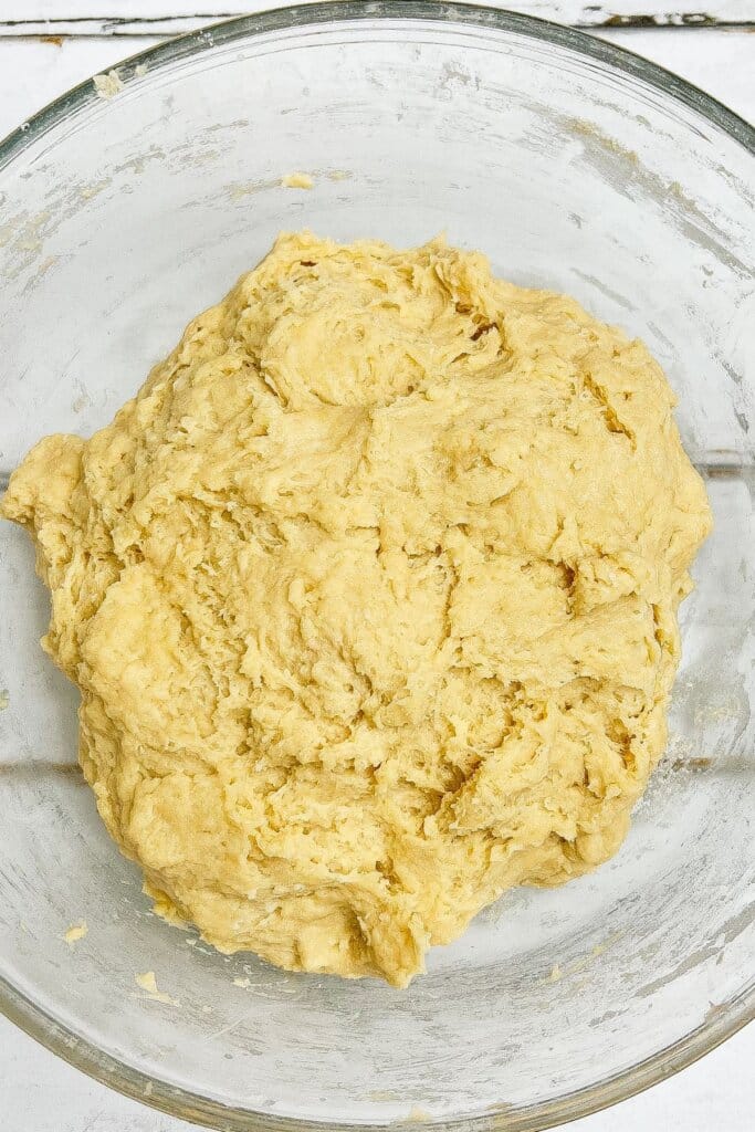 Dough resting in a glass mixing bowl.