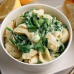 Bowl full of creamy spinach pasta.
