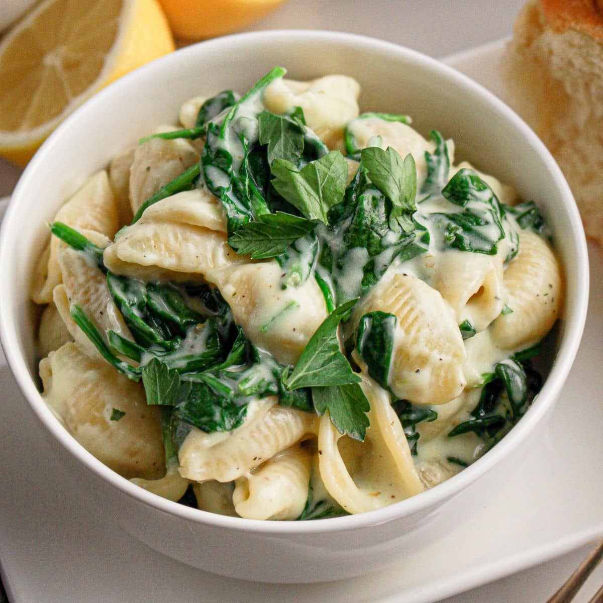 Bowl full of creamy spinach pasta.