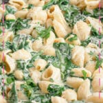 Bowl full of creamy spinach pasta.