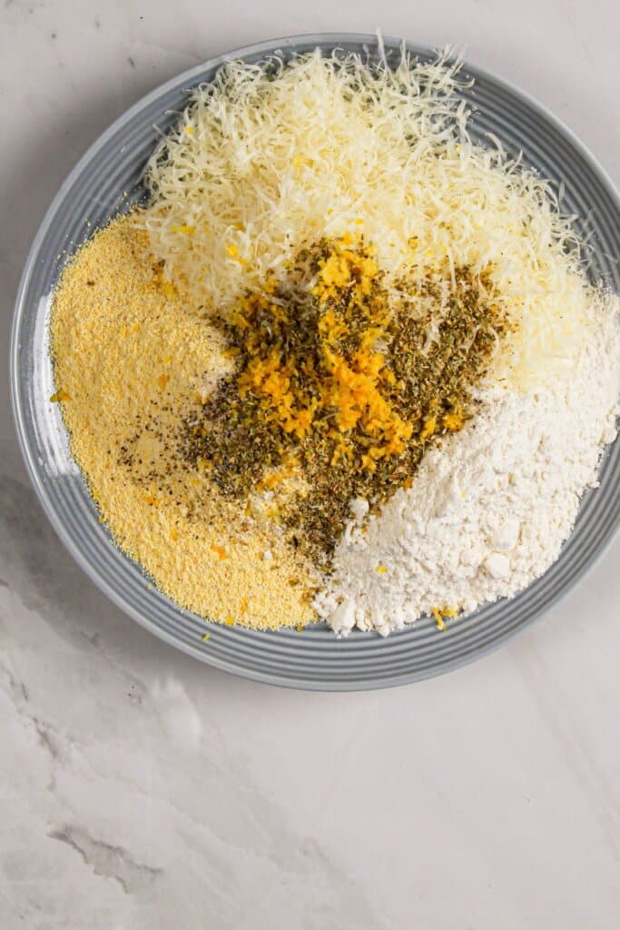 Cornmeal, parmesan cheese, and seasonings are mixed together.