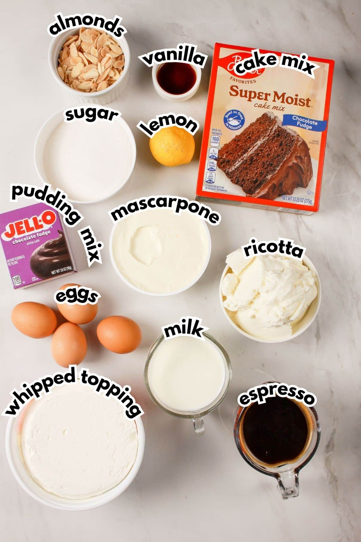 Bowls of ingredients labelled with text on a counter.