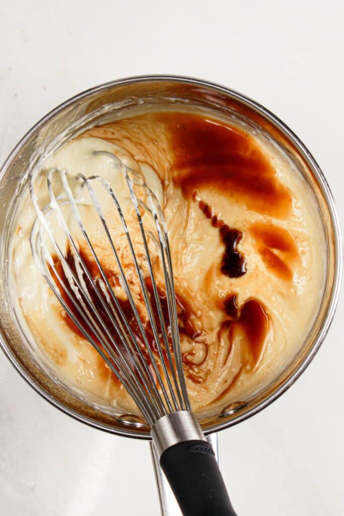 Frosting being mixed in a saucepan.