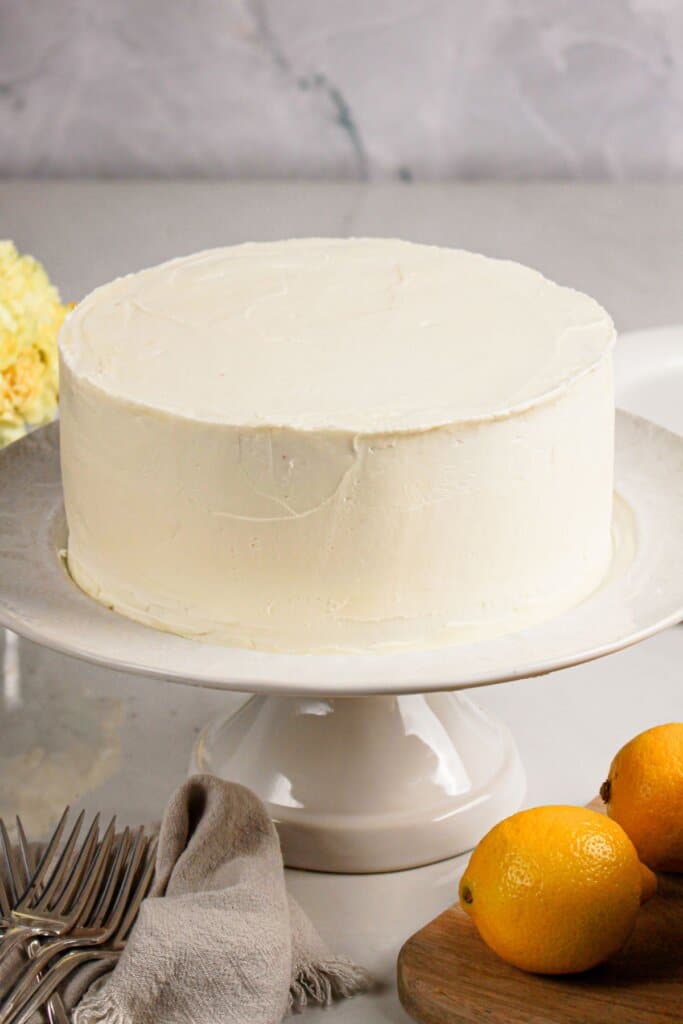 Frosted cake on a cake stand.