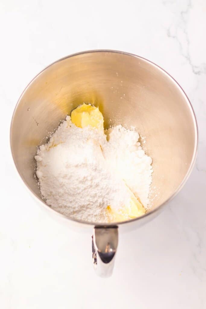 Powdered sugar and butter being mixed together.