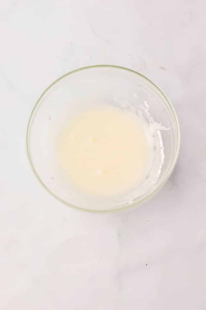 Icing in a small glass bowl.