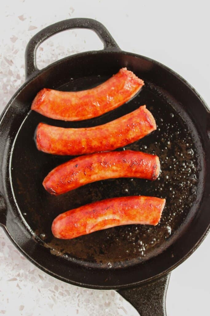 Sausages in a cast iron skillet.