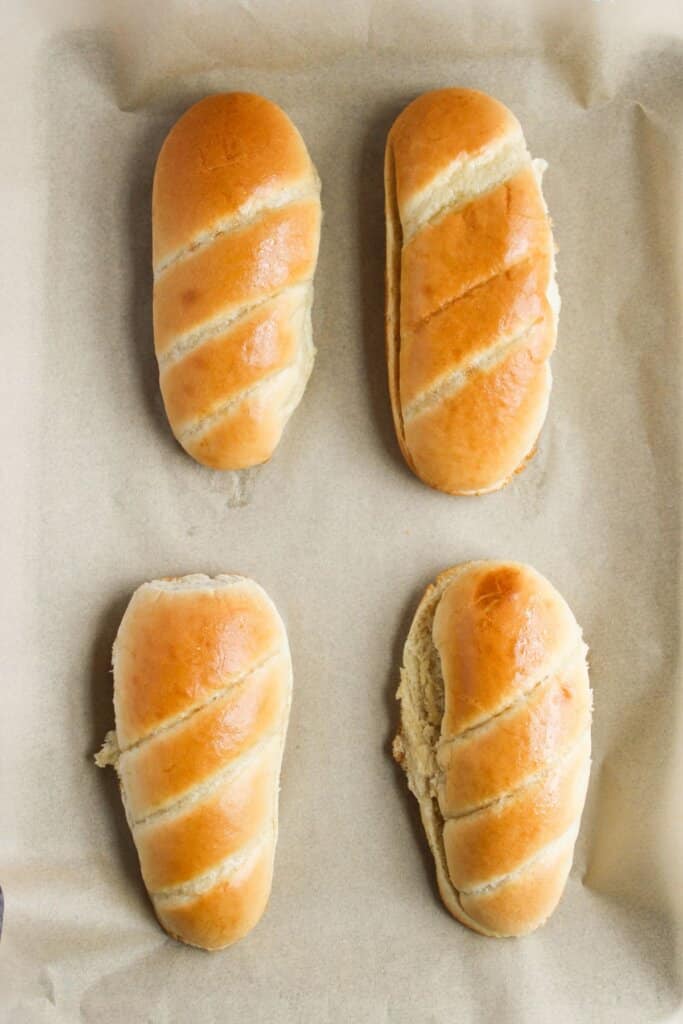 Buns on a parchment lined baking sheet.
