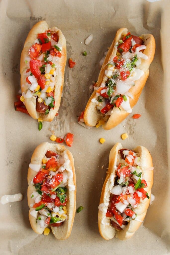 Tex mex sausage dogs on a baking dish.
