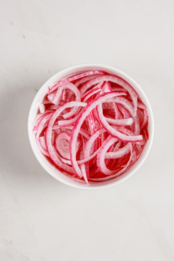 Red onions in a small bowl.