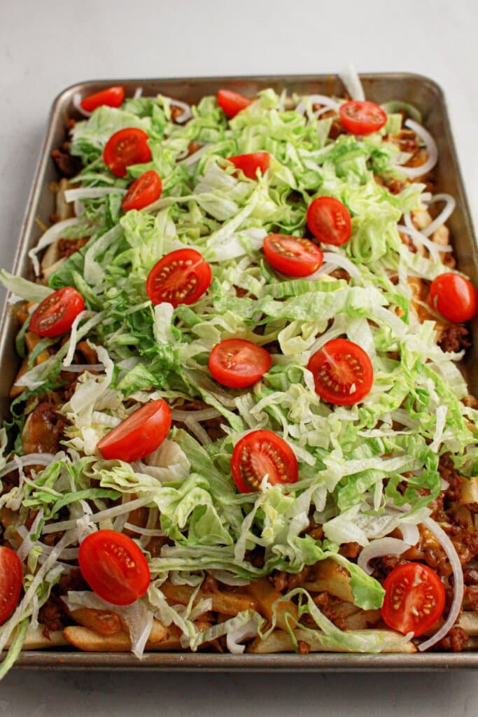 Tomatoes on top of baking sheet.